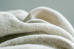 Delicate fabric texture offers a cozy touch at the bottom of a clean, bright background, perfect for showcasing natural and artisanal branding without distractions photo