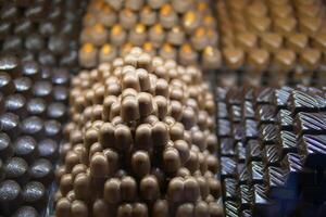 Chocolate confections stacked attractively in display case photo