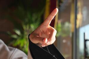 Hand raised in a gesture of communication during a conversation photo
