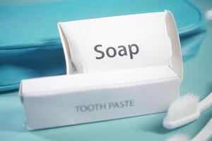 Soap and toothpaste packaging displayed on a colorful background photo