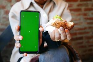Enjoying a meal while capturing moments on a smartphone photo