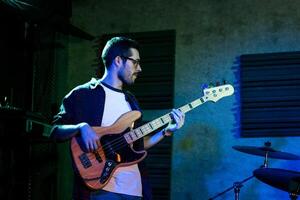 Bass Player In Stage With Colorful Lights photo