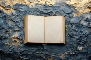 Open book displaying blank pages against textured blue gold surface, World Knowledge Day copy space mockup photo