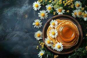 homemade pancakes with honey and daisies on a dark background, maslenitsa, shrove tuesday, or pancake day copy space photo