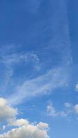 Stunning blue sky with wispy white clouds creating a peaceful summer atmosphere photo