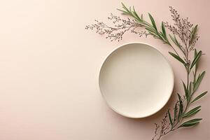 Empty beige plate lies on a pink background, decorated with fresh herbs, creating a minimalist backdrop with ample copy space photo