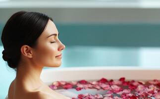 Relaxing spa self-care day concept. Woman relaxing in a bath surrounded by rose petals, enjoying a serene moment. photo