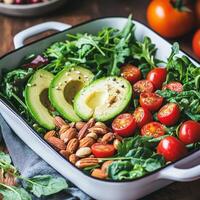 Healthy meal prep inspiration concept. Fresh salad with avocado, cherry tomatoes, almonds, and leafy greens in a rustic setting. photo
