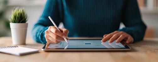 Digital transformation e-learning courses concept. A person using a tablet with a stylus, surrounded by a plant and a notepad on a table. photo