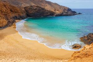 Exploring nature hidden gem concept. Secluded beach with golden sand and turquoise waters against rocky cliffs. photo