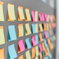 Project management coordination concept. Colorful sticky notes arranged on a gray board for organization and brainstorming tasks. photo
