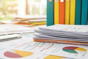 Project management coordination concept. Office workspace cluttered with colorful files, charts, and documents on a desk. photo
