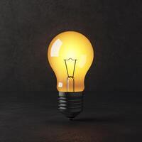 Inspirational success story motivation concept. A glowing light bulb illuminating a dark background. photo