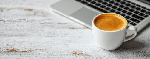 Startup brainstorming session concept. A cup of coffee beside a laptop on a rustic wooden table. photo