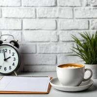Management efficiency and goal-setting concept. A cozy workspace with coffee, clock, and plant against a brick wall. photo