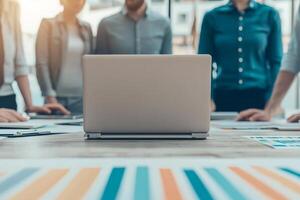 Teamwork trust and goal setting concept. A group of professionals collaborating around a laptop in a bright workspace. photo