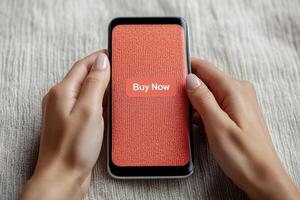 e-commerce checkout process concept A person holding a smartphone displaying a Buy Now button on a textured screen. photo