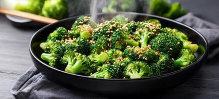 Broccoli stir-fry with sesame seeds concept. Freshly cooked broccoli garnished with sesame seeds in a stylish black bowl. photo