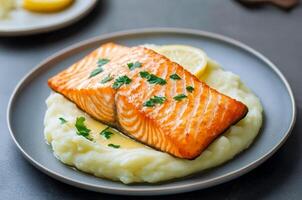 Salmon fillet with crispy skin concept. Delicious salmon fillet served over creamy mashed potatoes. photo