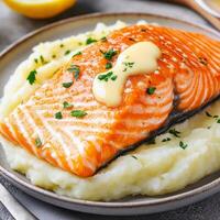 Salmon fillet with crispy skin concept. Delicious salmon fillet served on creamy mashed potatoes. photo