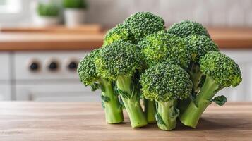 Raw broccoli in kitchen setting concept. Fresh broccoli on a wooden table in a bright kitchen setting. photo