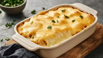 Vegan cheese alternative in dish concept. Baked lasagna topped with herbs in a ceramic dish on wooden surface. photo