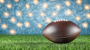 A brown football resting on lush green grass, with a soft, blurred background featuring bright lights, creating a vibrant sports atmosphere. photo