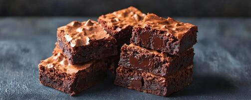 Rich brownie with chocolate chunks concept. Deliciously fudgy brownies stacked together, showcasing a rich chocolate texture and a tempting appeal. photo
