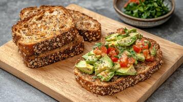 Plant-based diets Food concept. Sandwich featuring whole grain bread topped with fresh avocado, tomatoes, and herbs, served on a wooden cutting board. photo