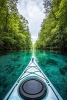 Adventure and Eco-tourism for travel concept. Kayak glides through crystal-clear waters, flanked by lush green trees, creating a tranquil natural setting. photo
