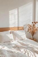 Self-care routines for Wellness concept. Bedroom featuring soft linens, a wooden headboard, and sunlit shadows casting beautiful patterns on the wall. photo