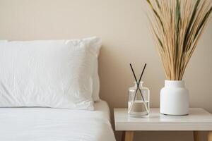 Self-care routines for Wellness concept. Bedroom scene featuring a white pillow, a glass vase with sticks, and a decorative plant, creating a calming atmosphere. photo