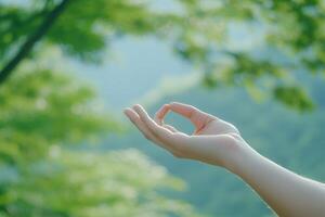 Lifestyle wellness with mental health and self-care concept. Gentle hand gesture against a serene natural backdrop. photo