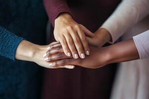 Social justice and community development concept. Hands of different skin tones coming together in unity. photo