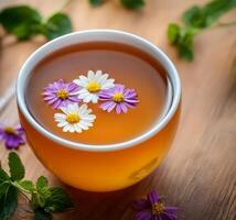 Lifestyle wellness with mental health and self-care concept. Tea with flowers floating, surrounded by greenery. photo