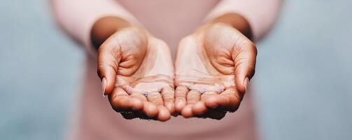 Non-profit volunteerism with social impact concept. Open hands offering water with a serene background. photo