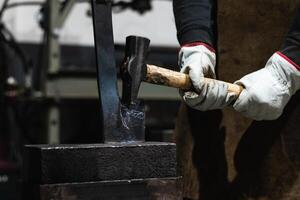 A person in a white glove is holding an axe photo