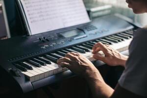 A person is playing the piano on a keyboard photo