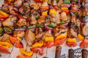top view of plate with skewers sticks of pork with vegetables photo