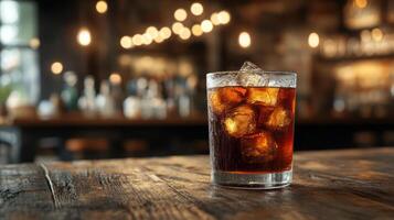 glass of rum and coke on bar photo