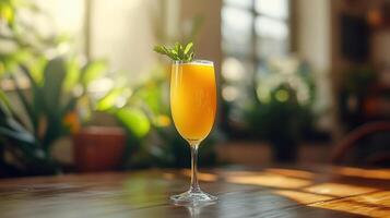 A glass of orange juice on a wooden table. photo