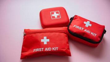 Three conspicuously arranged red first aid kits, clearly marked with white crosses, are prominently displayed for swift access and immediate readiness in case of emergencies that may arise photo