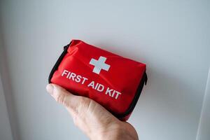 This is a Compact Red First Aid Kit that is specifically designed for Emergency and Outdoor Use, making it an essential piece of safety gear for all situations photo