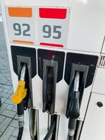 At the gas pump located at the filling station, you will notice it displays numbers 92 and 95, which represent the octane ratings of the gasoline that is being offered for vehicles photo