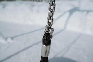 CloseUp of Chain Link and Swing Attachment in Snowy Landscape photo