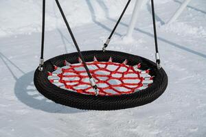 Experience the excitement of a Unique Circular Swing designed specifically for outdoor play, perfect for enjoying the magical atmosphere of a Winter Wonderland photo