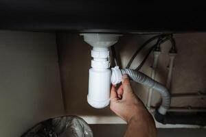 This guide details Hand Repairing Kitchen Sink Plumbing, providing a stepbystep method to fix a clogged drain pipe under the sink for better home maintenance photo