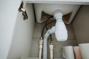 The bathroom sink has a drain pipe connected to the plumbing system, ensuring efficient wastewater disposal and promoting cleanliness, hygiene, and health in your household photo