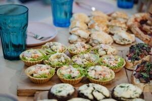 There are numerous and various different types of delicious food items displayed beautifully on the table, inviting everyone to enjoy and indulge in a wonderful culinary experience photo