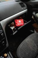A first aid kit is conveniently stored in the glove box of the car, ensuring that in the event of any emergency, immediate assistance is readily accessible for all passengers and occupants photo